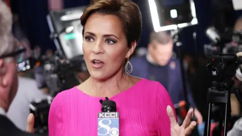 Getty Images Kari Lake speaking to reporters