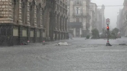Reuters Streets are flooded during heavy rainfall on the island of Sicily, in Catania