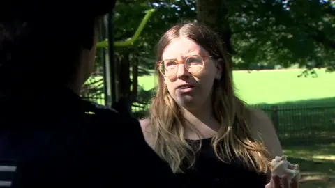 A mother at a park in Bristol speaking to police about coronavirus rules