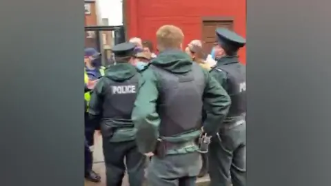 BBC Uniformed officers arrested a man at the wreath-laying ceremony