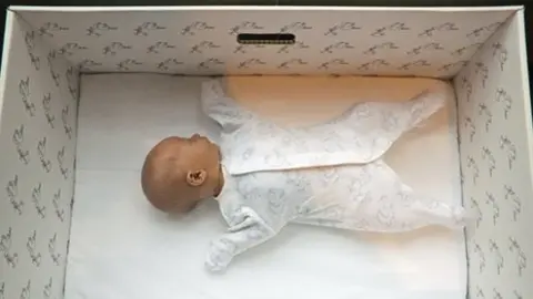 Milla Kontkanen Baby asleep in one of the maternity boxes