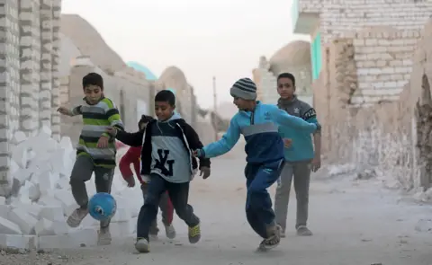 Reuters Children play football at the Zawiyyet al-Mayyitee cemetery near Minya, Egypt Tuesday 8 January 2019
