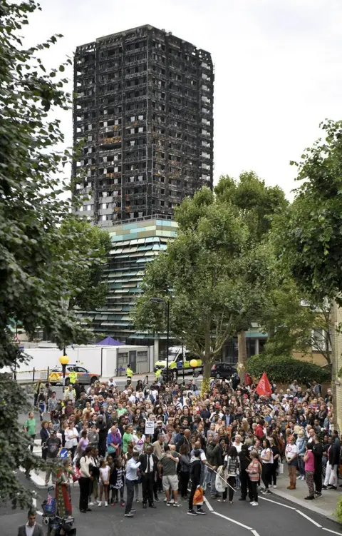 Getty Images Friends and relatives of victims of the Grenfell Tower fire joined local residents for a silent march to mark the second month since the disaster