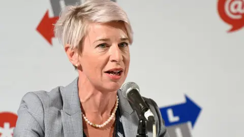 Getty Images Katie Hopkins is seen sitting in front of a microphone