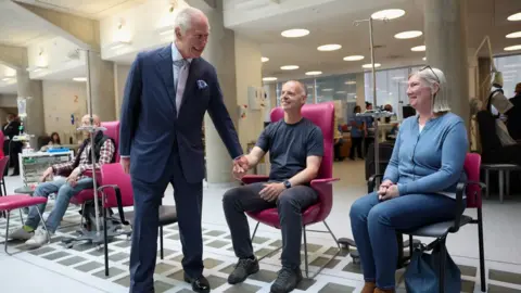 Reuters King Charles smiles as he talks to cancer patients in London