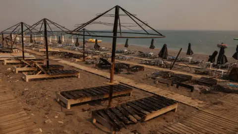 Reuters Sun loungers on a beach have been burned.