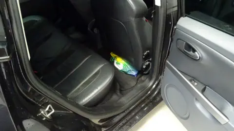 West Midlands Police Picture taken by an MI5 officer of a bag inside Naweed Ali's car, packed under the driver's seat, in which investigators found a cleaver, replica gun and pipe bomb during a search in August 2016