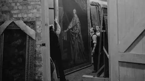 Hulton Archive/Getty Images A huge painting of Cardinal Richelieu by Philippe de Champaigne is brought out for inspection by art experts.