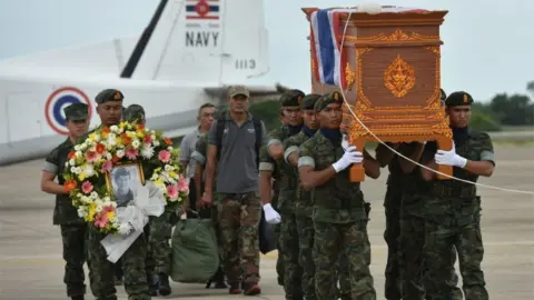 Reuters Saman Gunan's coffin is carried by soldiers