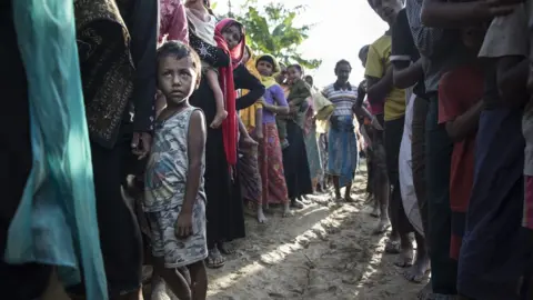 Getty Images New Rohingya arrivals wait in line for humanitarian food aid from Action Against Hunger ( Action Contre La Faim ) mobile emergency support - 24 September 2017