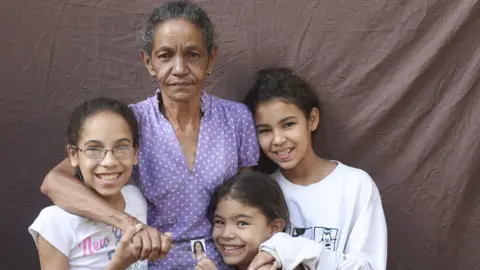 Caritas Maribel Pérez, 62, with her grandchildren (from left to right) Naile, 12, Naiberli, 7 and Naire, 13