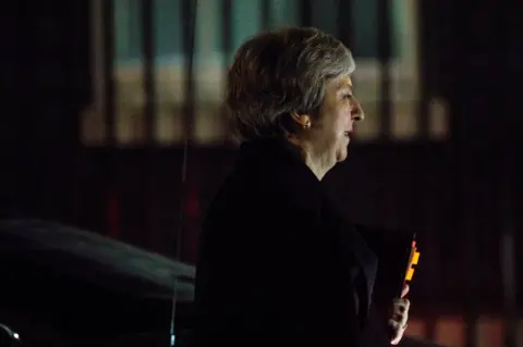 Getty Images Theresa May arrives at No 10 after postponing the Commons vote on her Brexit deal