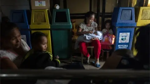Getty Images Residents in an evacuation centre in the Gonzaga, Philippines, as Typhoon Mangkhut battered the north, 15 September, 2018