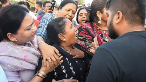 Reuters Family members react as they reach Harni Lake where a boat carrying children and teachers who were on a picnic capsized in Vadodara, India, January 18, 2024. REUTERS/Stringer NO RESALES. NO ARCHIVES