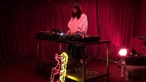 Open Windows Kitty Clark performing at SET's Bar in Dalston. The bar provides a source of income and helps to promote musicians and artists