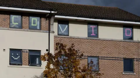 Getty Images  Covid written in student halls windows in Cardiff