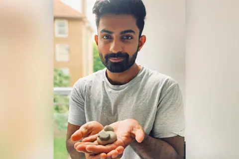 BBC/Kavita Puri Sparsh Ahuja holding his three pebbles