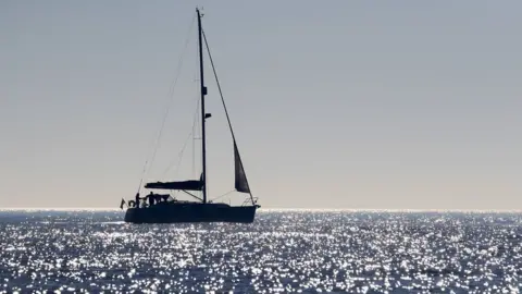 PA A sailing boat off the coast of Dungeness, Kent