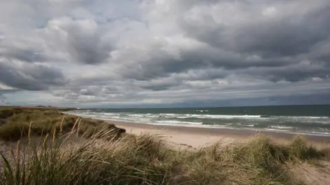 Bruce Cutts/Natural england An empty Northumberland beach with grassy dunes