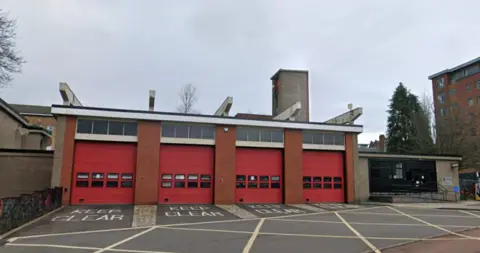Google A fire station with four red doors with Keep Clear signs in front
