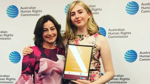 Beck Robertson Georgie with her mother, Beck Robertson, after winning the Young People's Human Rights Medal 2017