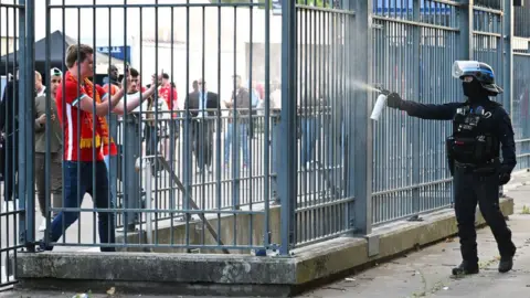 Getty Images Police officer using CS spray on a Liverpool fan