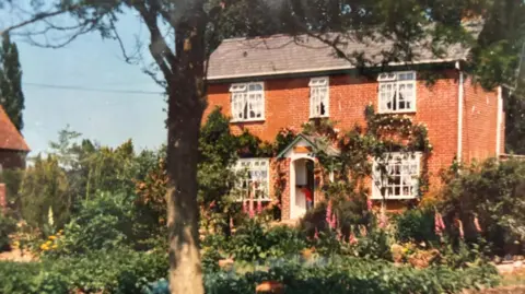 An old photograph of the house.