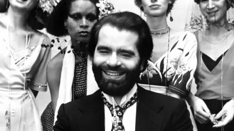 AFP Taken on November 29, 1973 shows German fashion designer Karl Lagerfeld posing with models after receiving an award in Krefeld, western Germany
