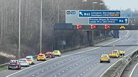 View of police cars on hard shoulder and right lane on an emptied motorway.