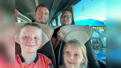 family photo  Tony Mattravers, along with his wife and two young children, waited more than 18 hours for their flight to be postponed to the next day