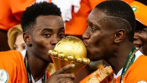 Ivory Coast celebrate after receiving the Afcon trophy on Sunday night.