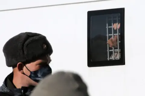 Getty Images A man detained during a unsanctioned protest rally at Manezhnaya Square in front of the Kremlin,