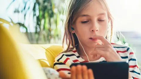 Kerkez/Getty Images Child on phone