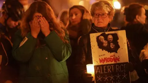 Getty Images People gathering in front of ruling Law And Justice (PiS) party office to protest against abortion ban are seen in Gdansk, Poland, on 1 November 2021