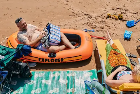 David Hares Warren in his boat on the beach in Torquay