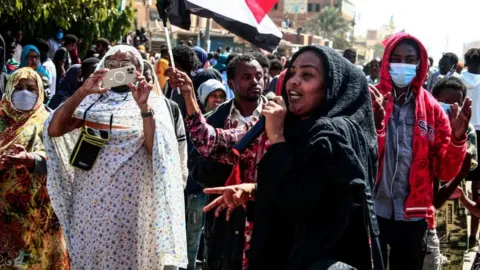 AFP A Sudanese woman speaks during in a rally to protest against last year's military coup, in the capital Khartoum, on January 30, 2022