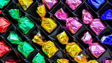 Getty Images A selection of individually wrapped chocolates.