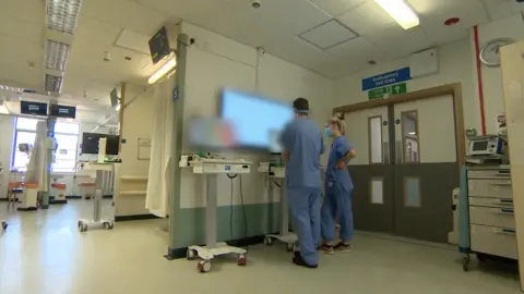 BBC Hospital scene, with medic looking at screen