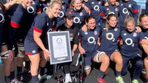 BBC Lexi Chambers being given a world record certificate at Sandy Park in Exeter, by the England Women's rugby team