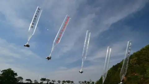 Getty Images South Korean and US activists release balloons carrying anti-Pyongyang leaflets at a field near the Demilitarized zone