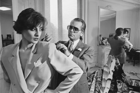 Pierre Vauthey/Sygma/Getty Images Karl Lagerfeld fits one of his designs on top model Ines de la Fressange at Chloe's Paris studio.