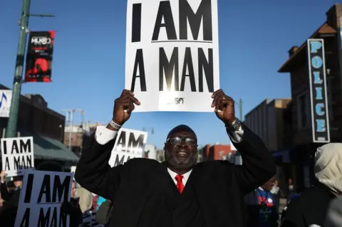 Getty Images A man holds a sign declaring 'i am a man'