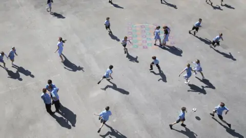 Getty Images Playground full of primary school children