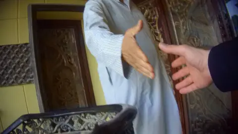 Two anonymous hands reaching out to each other for a handshake