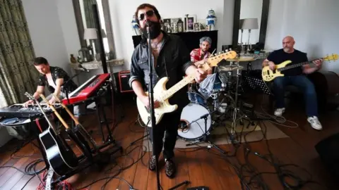 Reuters Todd Sharpville and his band jam in their makeshift studio as they isolate together with their families and pets in a rented luxury estate, as lockdown caused by the coronavirus disease (COVID-19) continues, in Sheringham