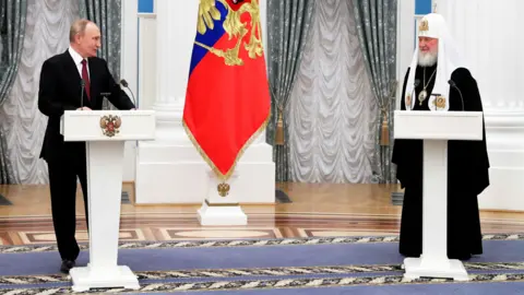 Getty Images President Vladimir Putin with Patriarch Kirill of Moscow and All Russia, 20 November 2021