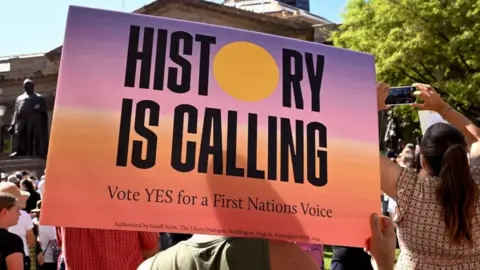 Getty Images A person holds a Yes sign at a Sydney rally