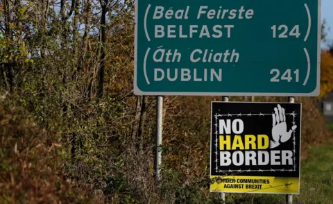 Reuters Road signs on the Irish border listing the distances to Belfast and Dublin