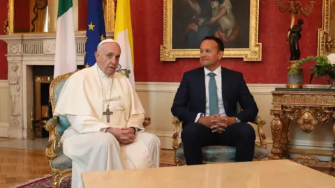 PA Media Pope Francis sitting beside former Taoiseach Leo Varadkar inside Dublin Castle. 