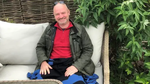 Sue Archer Marcus Whitehead in his garden